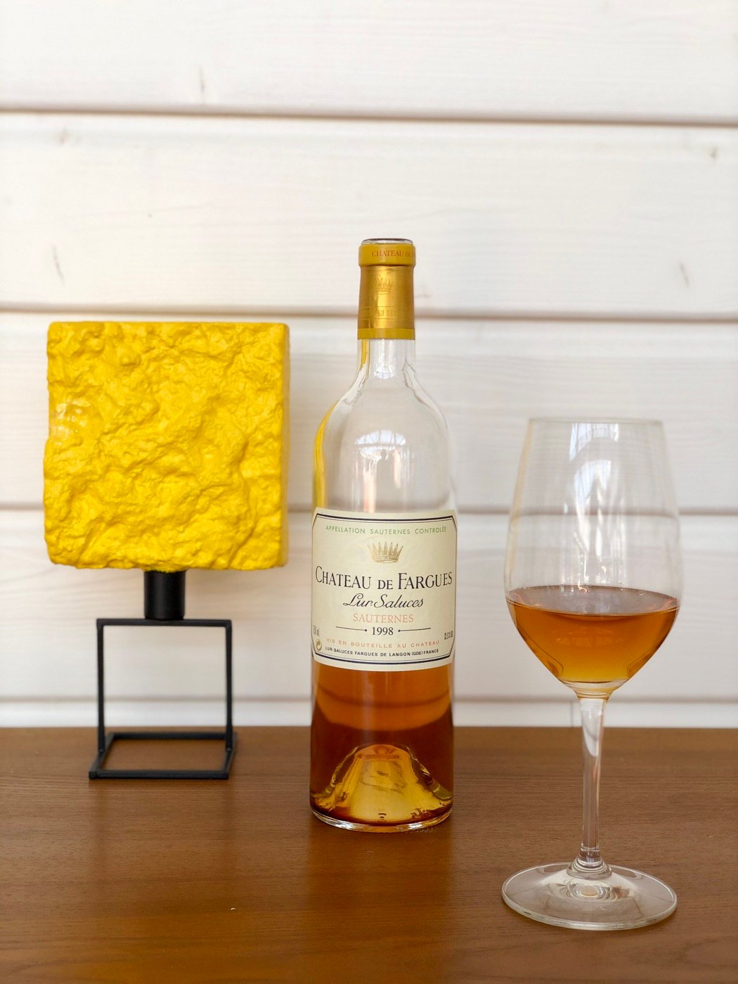 A bottle of Sauternes and a glass of golden wine