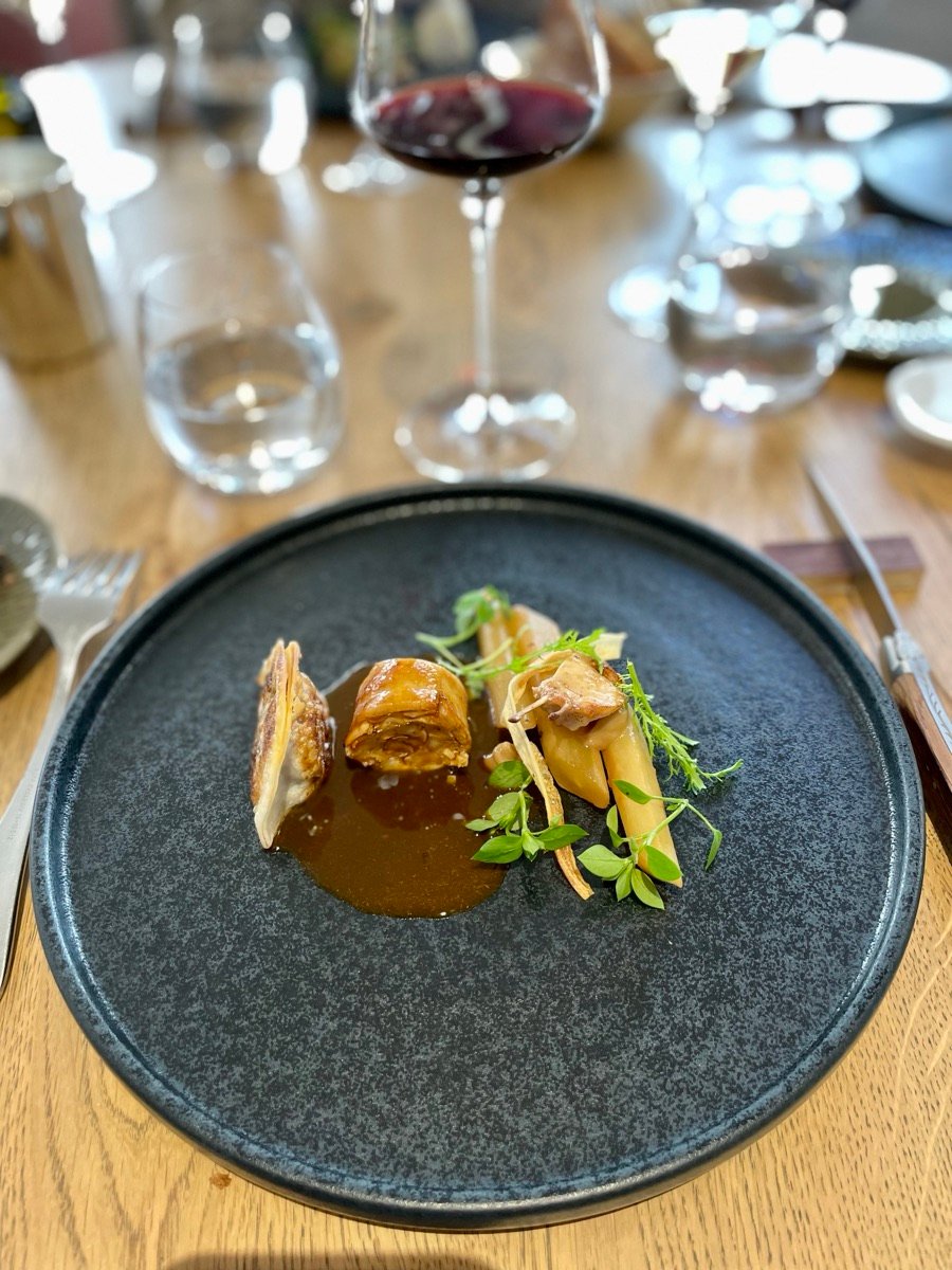 A gastronomic plate served with a glass of red wine