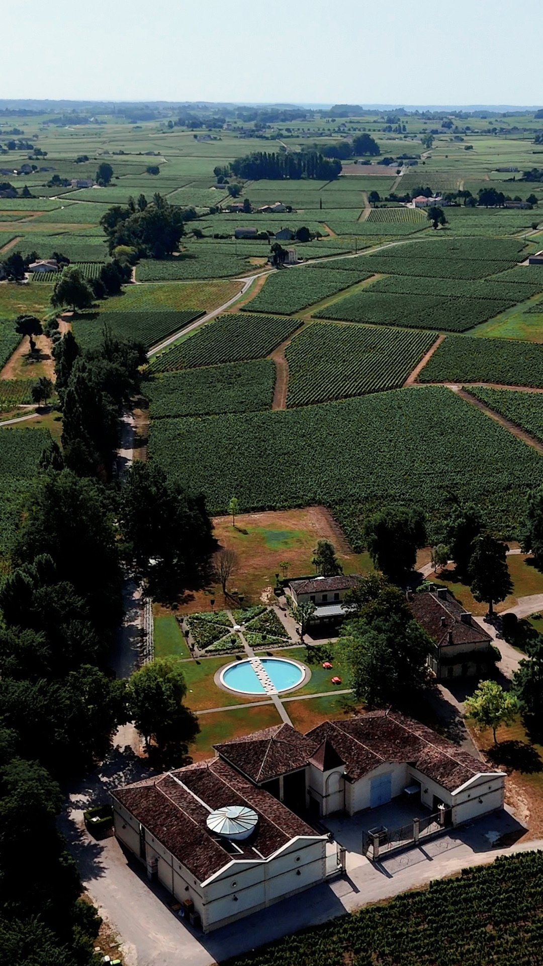 A château, its gardens and its vineyards seen from the sky
