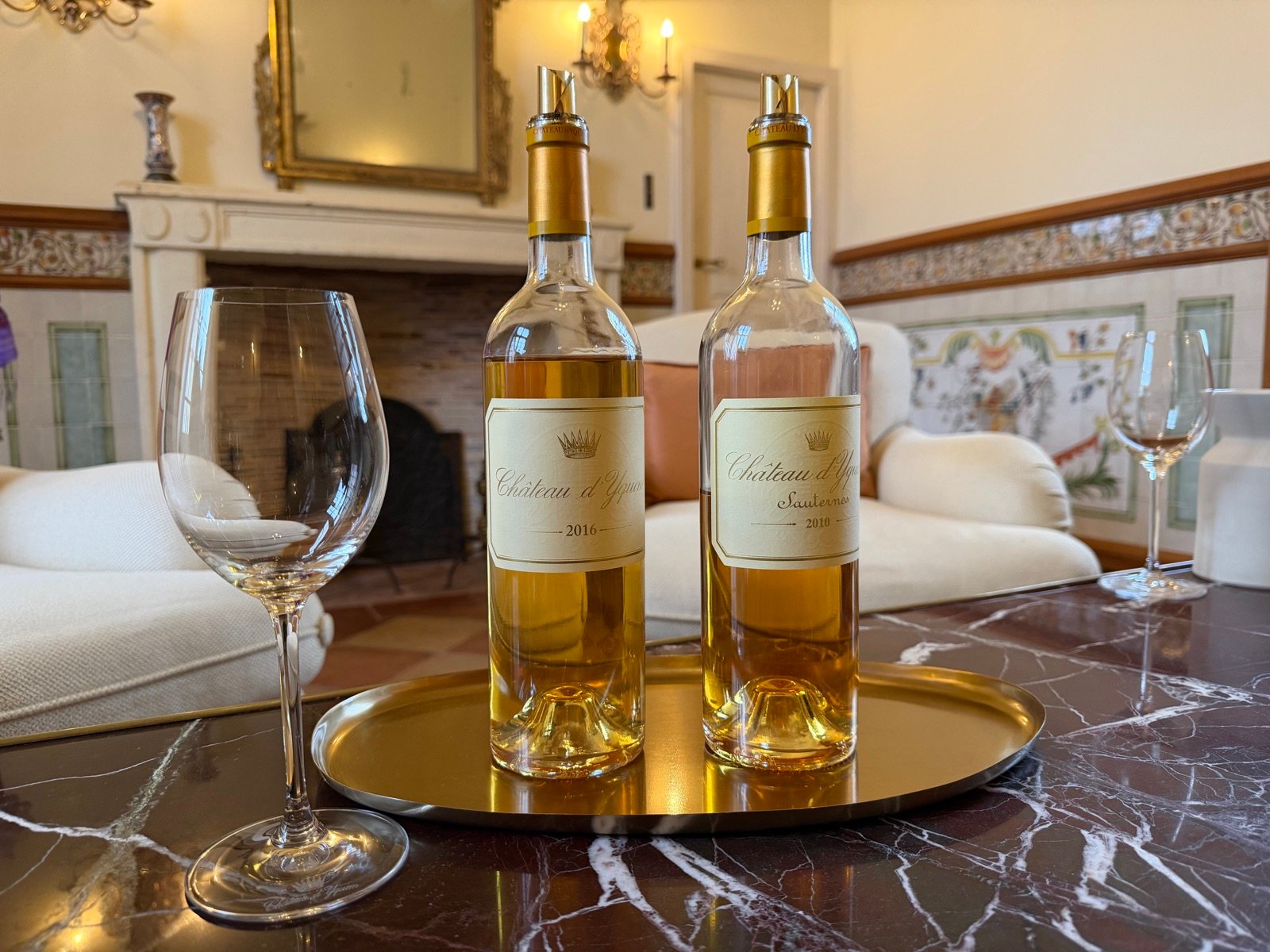 Two bottles of Sauternes and glasses in a château drawing room
