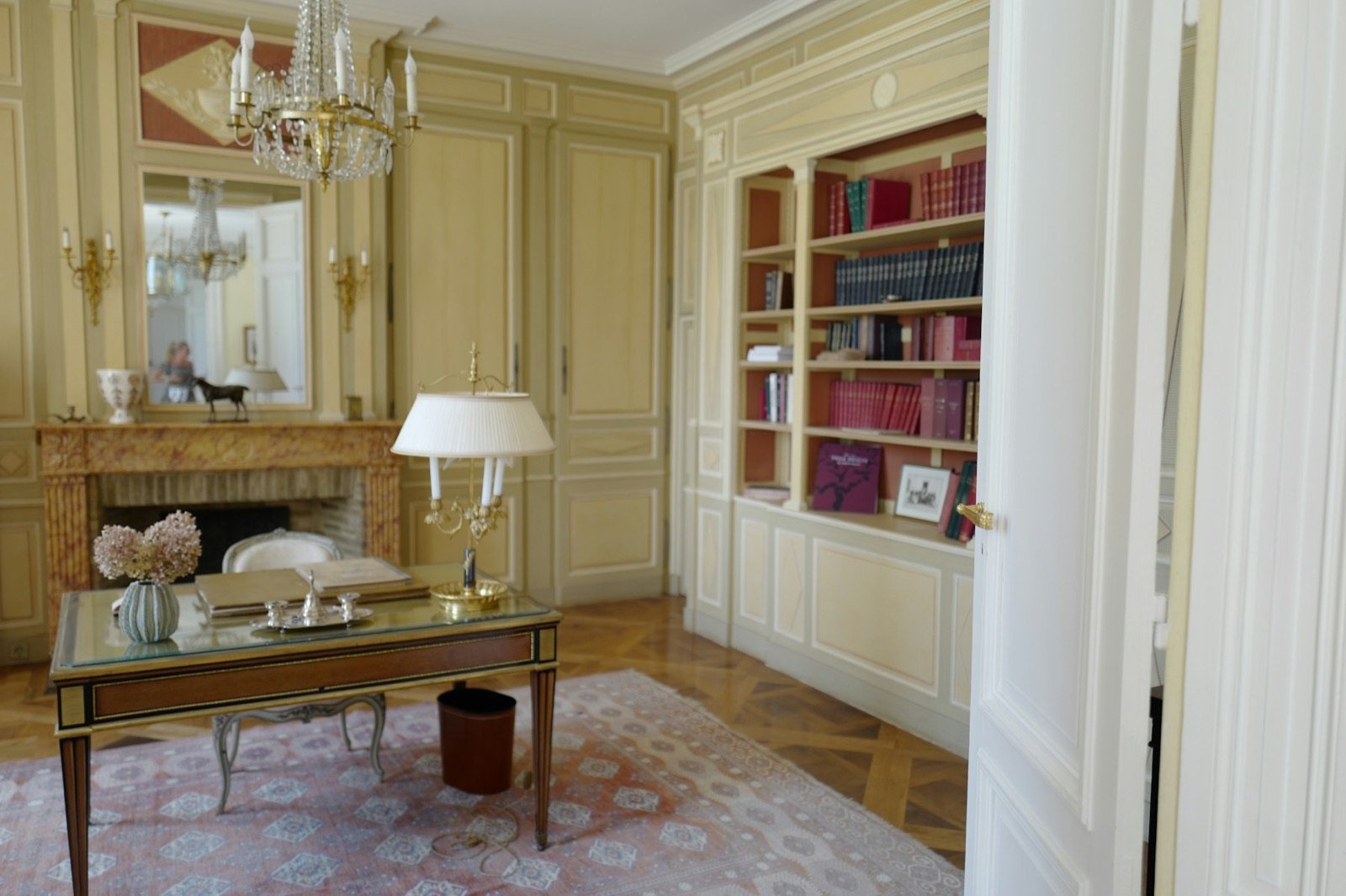 A bright living room with a fireplace and bookshelves